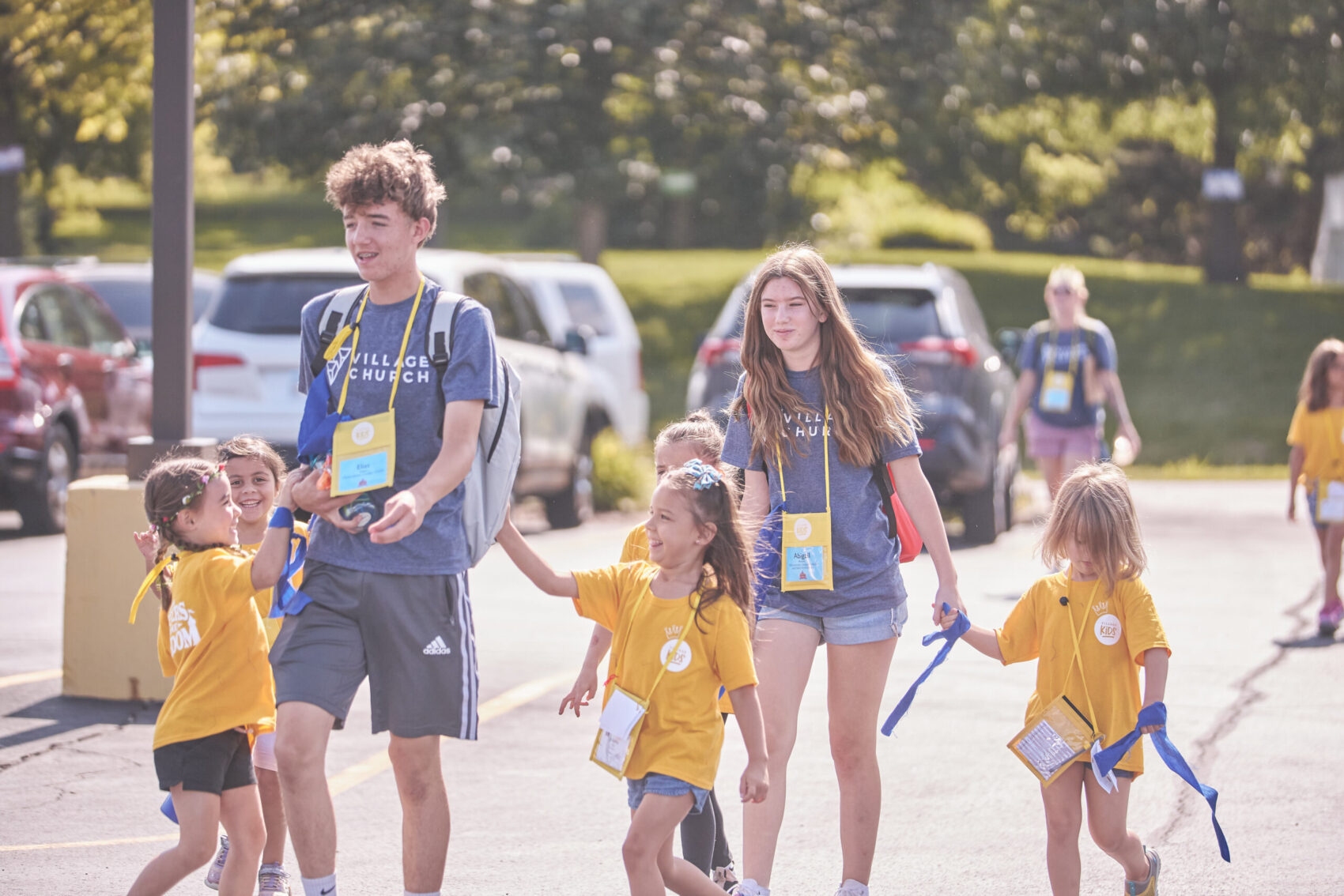 vbs 2023 counselors and kids walking in parking lot