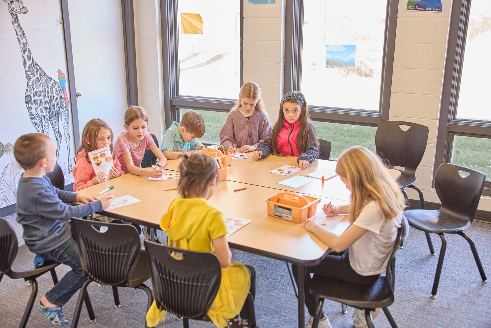 village kids in classroom coloring