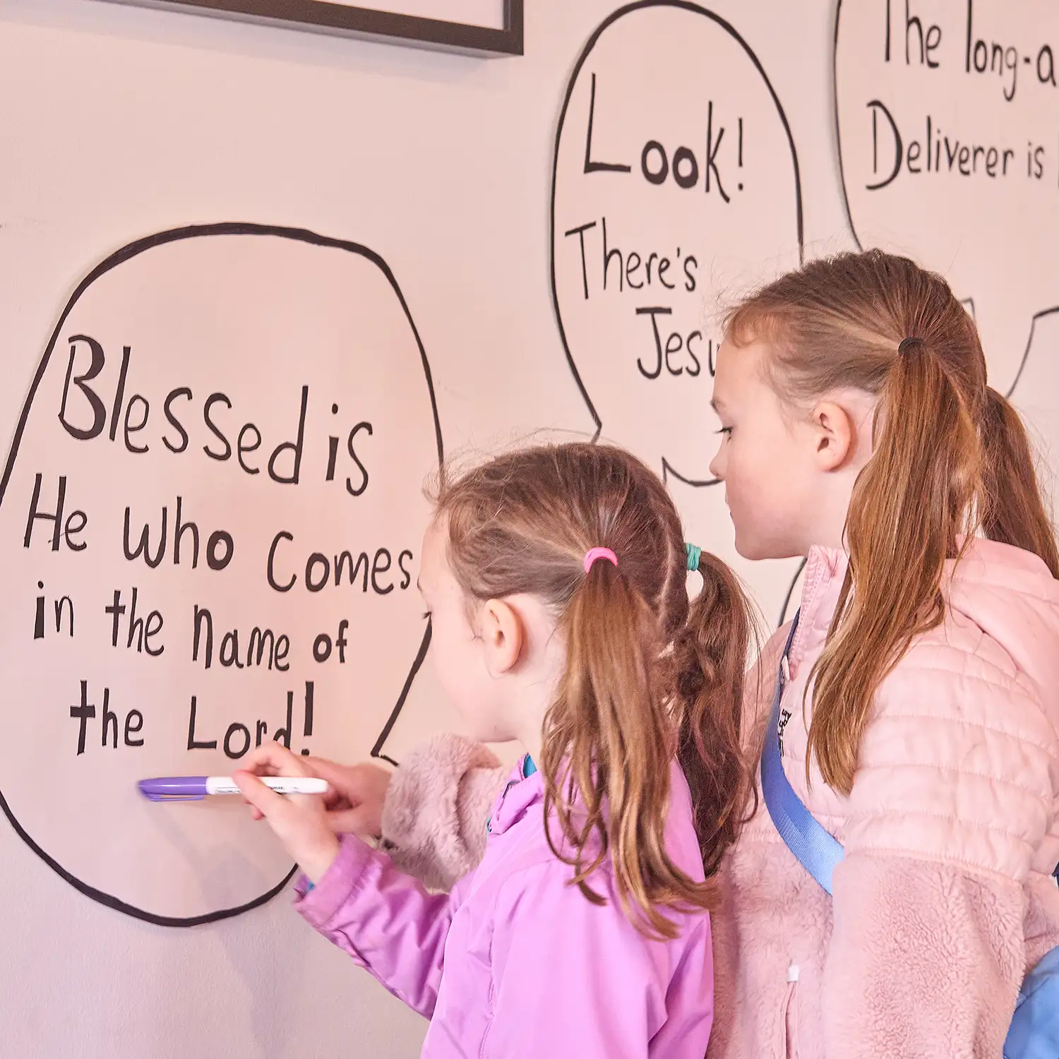 Village Kids Sundays two girls writing on the white board